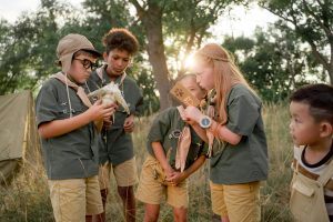 Group of young people learning outdoor skills in nature