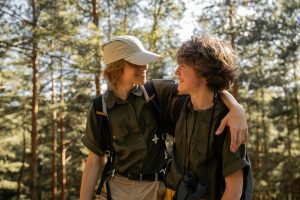 2 young people smiling and hugging in nature