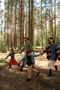 Happy parents and two children in nature