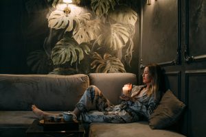Woman relaxing with a candle and tea